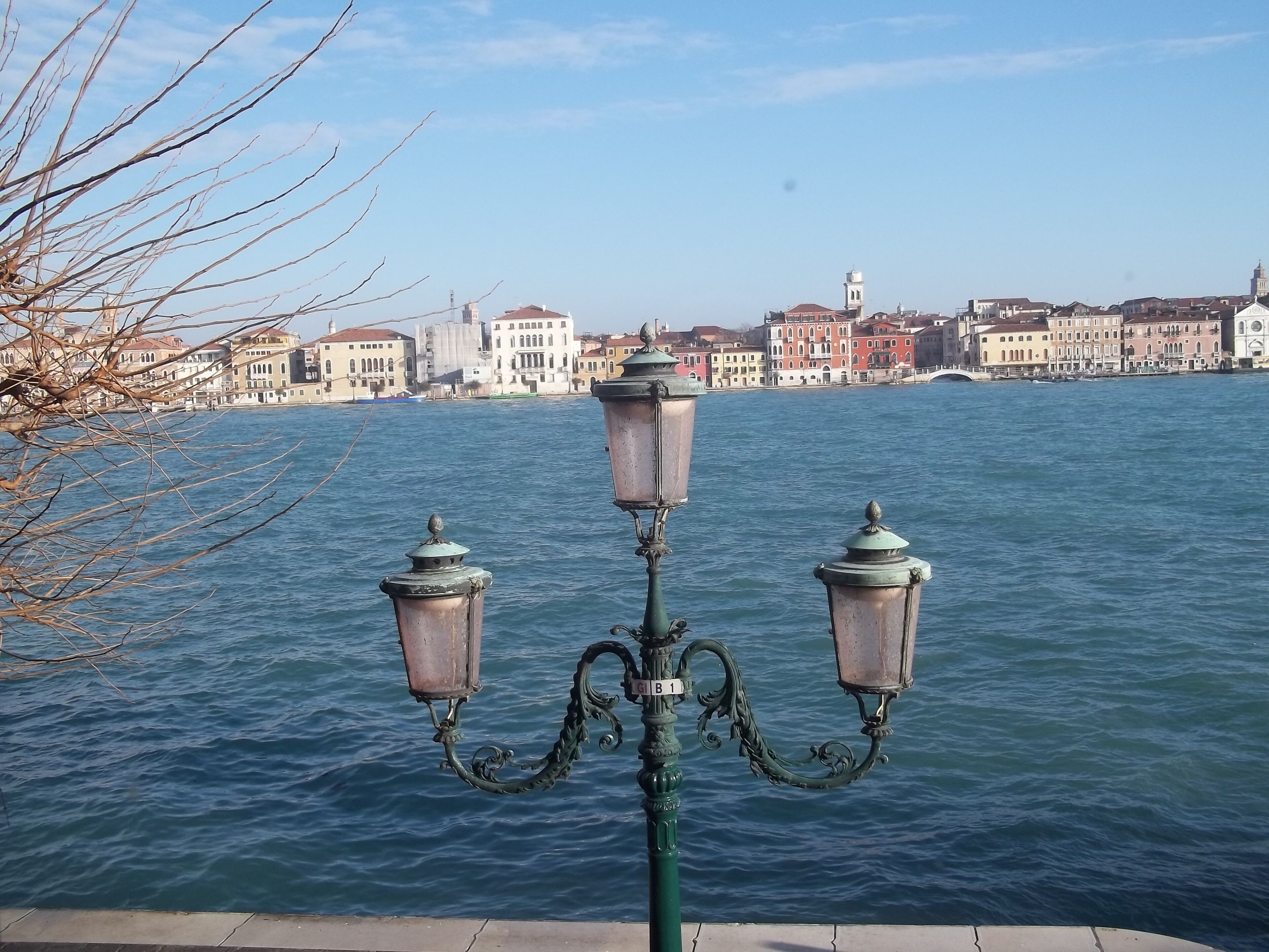 A waterfront view with a row of buildings in the background.