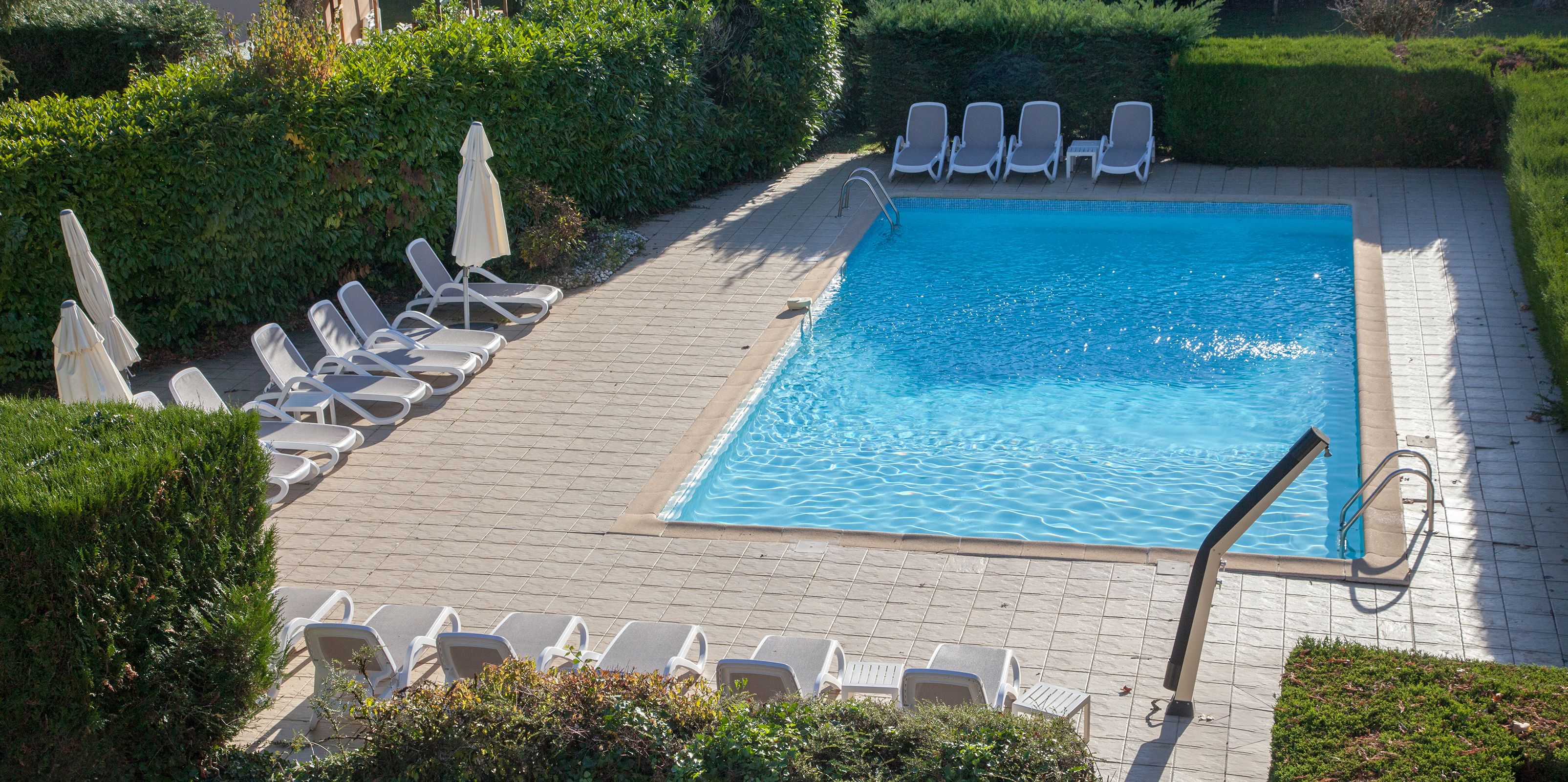 seasonal outdoor pool, open 9:00 am to 9:00 pm, pool umbrellas