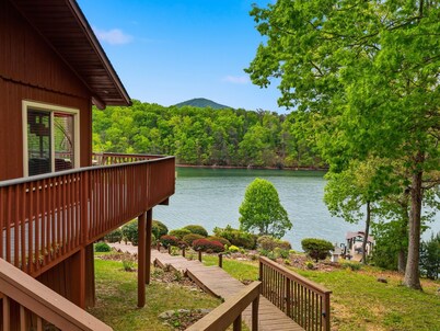 This cozy 2-bedroom, 1-bath retreat is wrapped in warm cedar with soaring cathedral ceilings, creating the perfect blend of rustic charm. Enjoy beautiful gardens and breathtaking views of the lake and mountain.