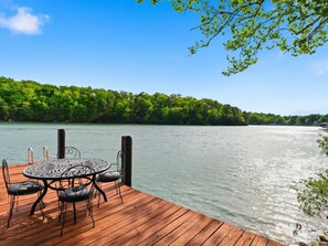 Outdoor dining - This cozy 2-bedroom, 1-bath retreat is wrapped in warm cedar with soaring cathedral ceilings, creating the perfect blend of rustic charm.  Enjoy beautiful gardens and breathtaking views of the lake and mountain. (Huddleston)