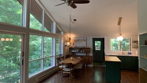 A spacious kitchen with a dining area, large windows, and a ceiling fan. - The Red House - Eugenia - Beaver Valley, Ontario, Canada (Eugenia)