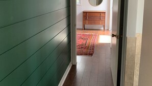 A hallway with green walls, a wooden floor, and a mirror on the wall. - The Red House - Eugenia - Beaver Valley, Ontario, Canada (Eugenia)