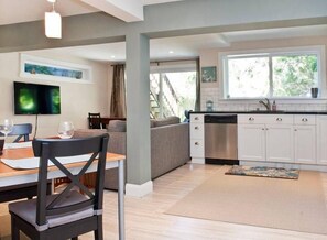 Enjoy meals in the dining area with a flat-screen TV and comfortable seating.