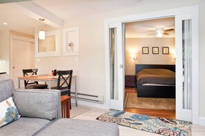 Relax in a spacious living area with a sofa, dining table, and comfortable seating.