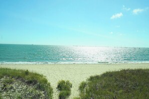 A beach with a clear sky and calm sea. - New Coastal House, Steps to Keyes Beach, Main Street, Harbor; AC, Linens, Wi-Fi (Hyannis)
