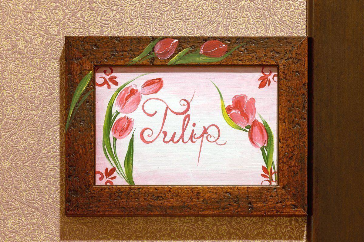 A framed artwork with the name "Tulip" and red tulips.