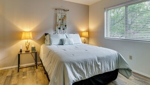 A bedroom with a bed, two bedside lamps, a ceiling fan, a window with blinds, and a wall-mounted tapestry. - Mom's Place in Jemez - 1 Mi to Hot Spring (Jemez Springs)