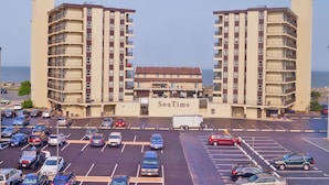 A parking lot with multiple cars and a building labeled "SeaTime" in the center. - Seatime 303S-Oceanside 136th St, Free WiFi, Pool, Elev, W/D, AC (Ocean City)