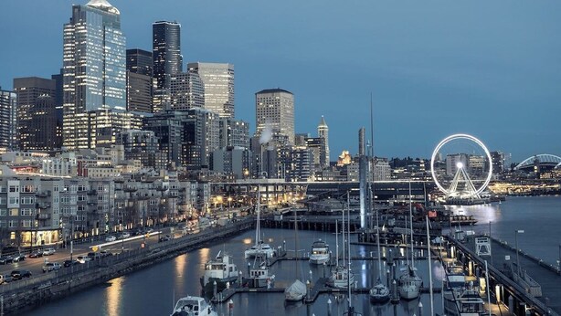 A city skyline with modern high-rise buildings, a waterfront marina, and a prominent Ferris wheel. - Modern studio in the heart of the city (Seattle)