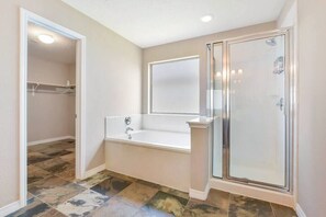 A bathroom with a walk-in shower, a bathtub, and a large mirror. - Stunning Home In Beautiful Spring (Montgomery County)