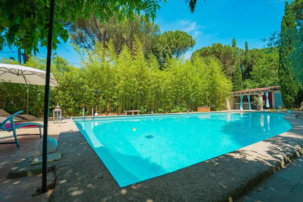 Seasonal outdoor pool, open 10:00 AM to 10:00 PM, pool umbrellas