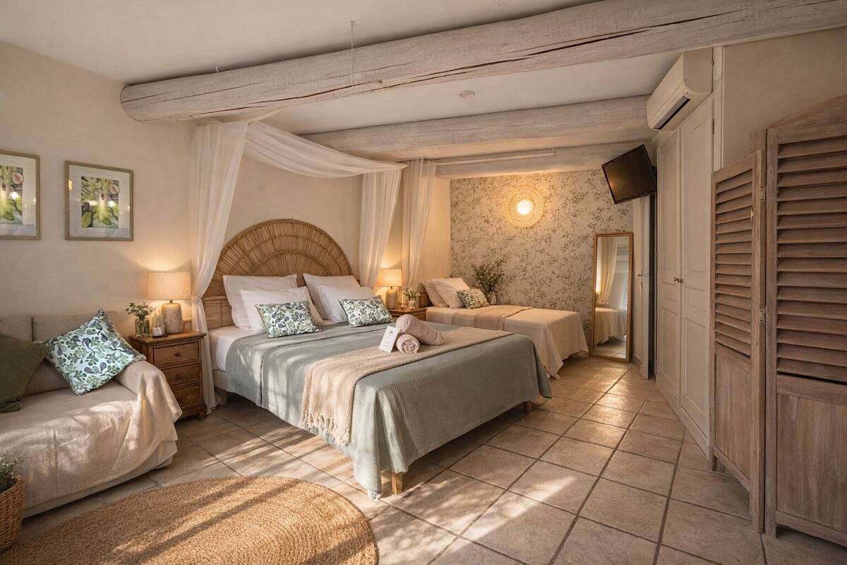 A bedroom with a large bed, two bedside tables, a mirror, and a wardrobe.