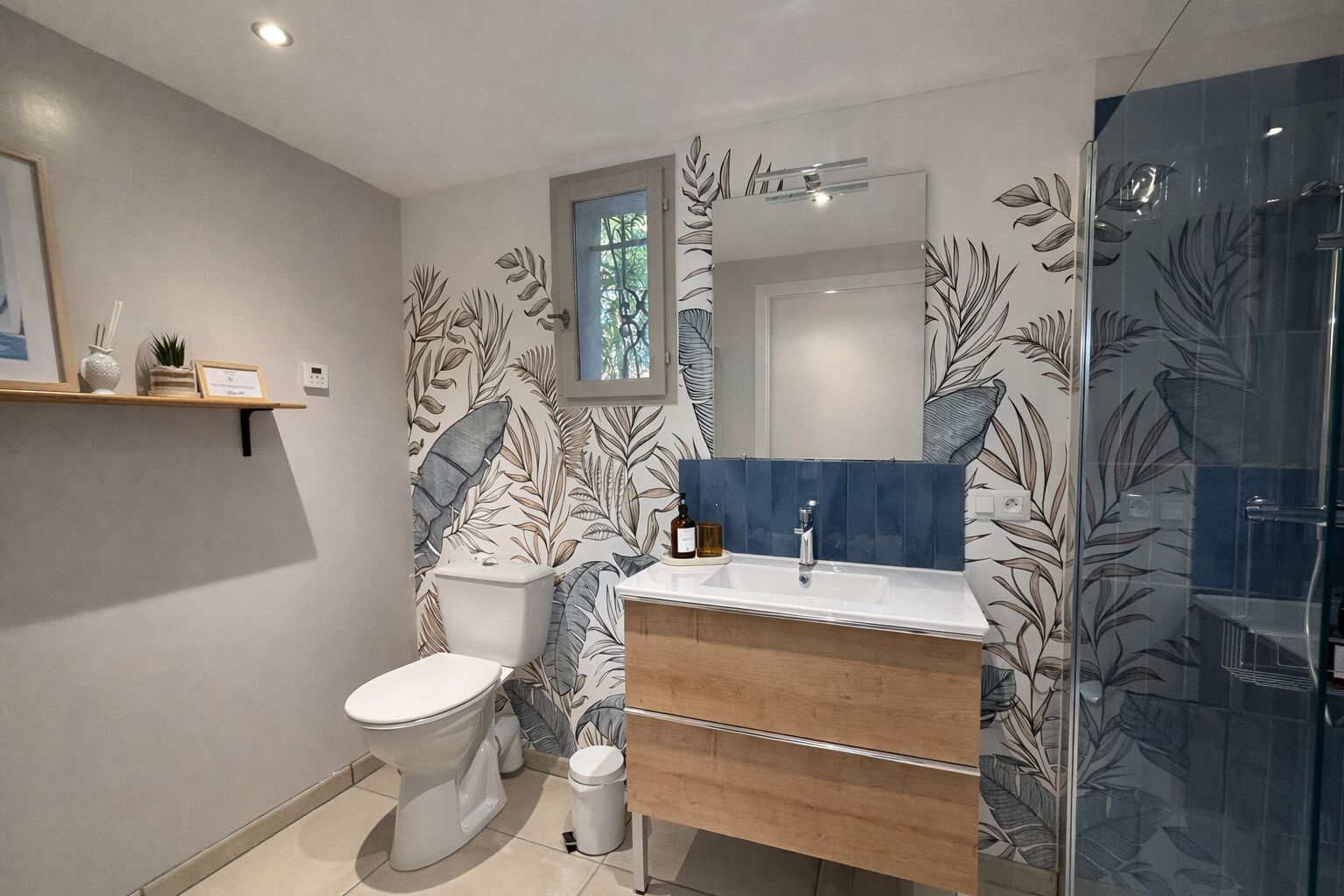 A bathroom with a toilet, sink, and shower.