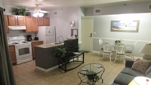 A compact living space with a kitchenette, dining area, and seating area.