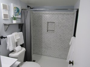 Bathtub, hair dryer, towels, soap