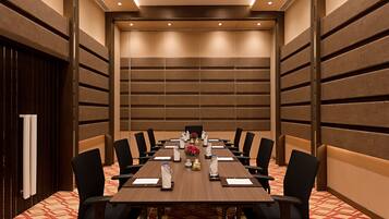 A conference room with a long table, chairs, and a decorative centerpiece.
