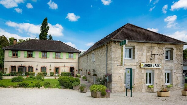 A hotel with a stone facade and a sign reading "Auberge de la Plaine". - Auberge De La Plaine (La Rothiere)