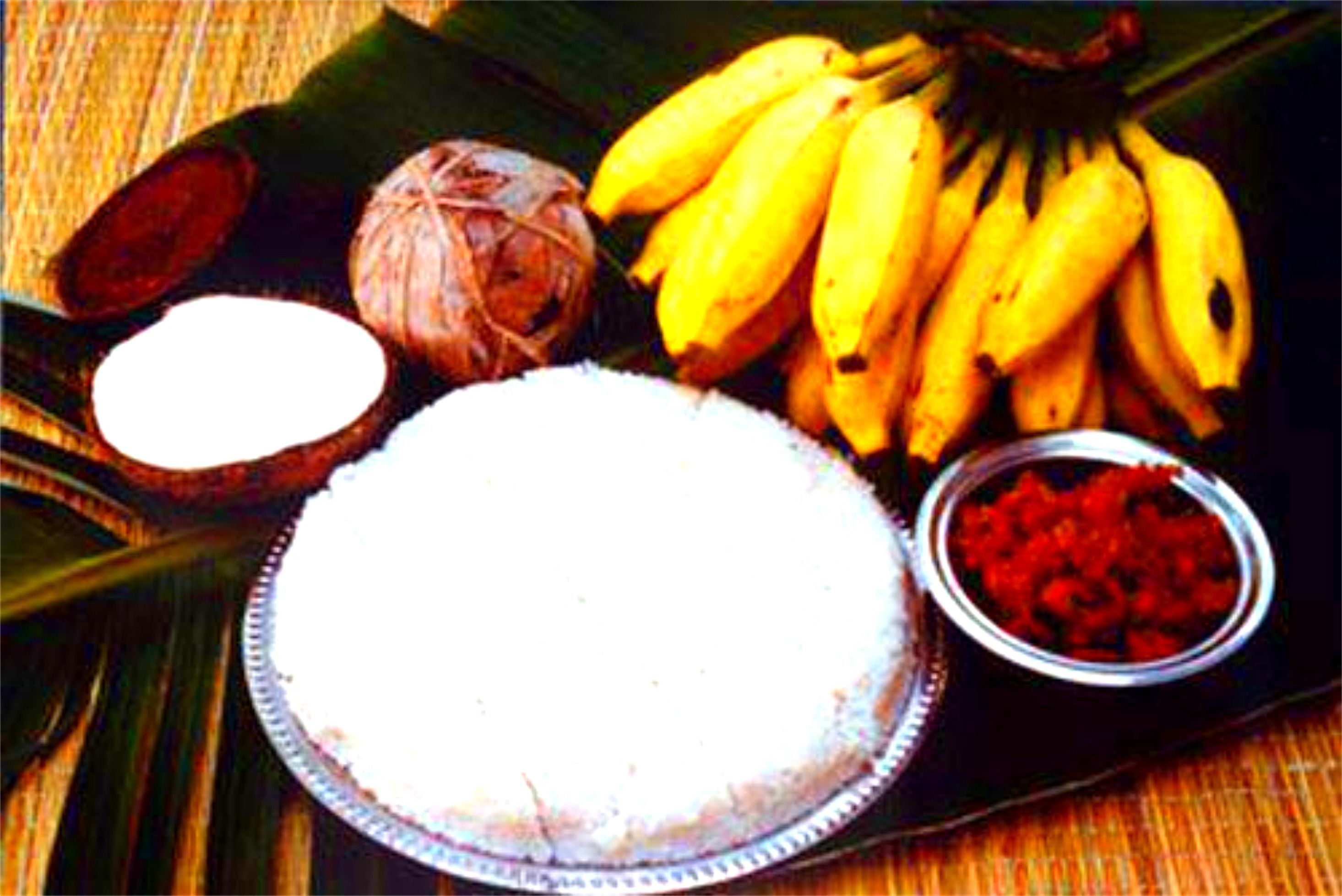 A plate of food with bananas, coconut, and a bowl of red sauce.