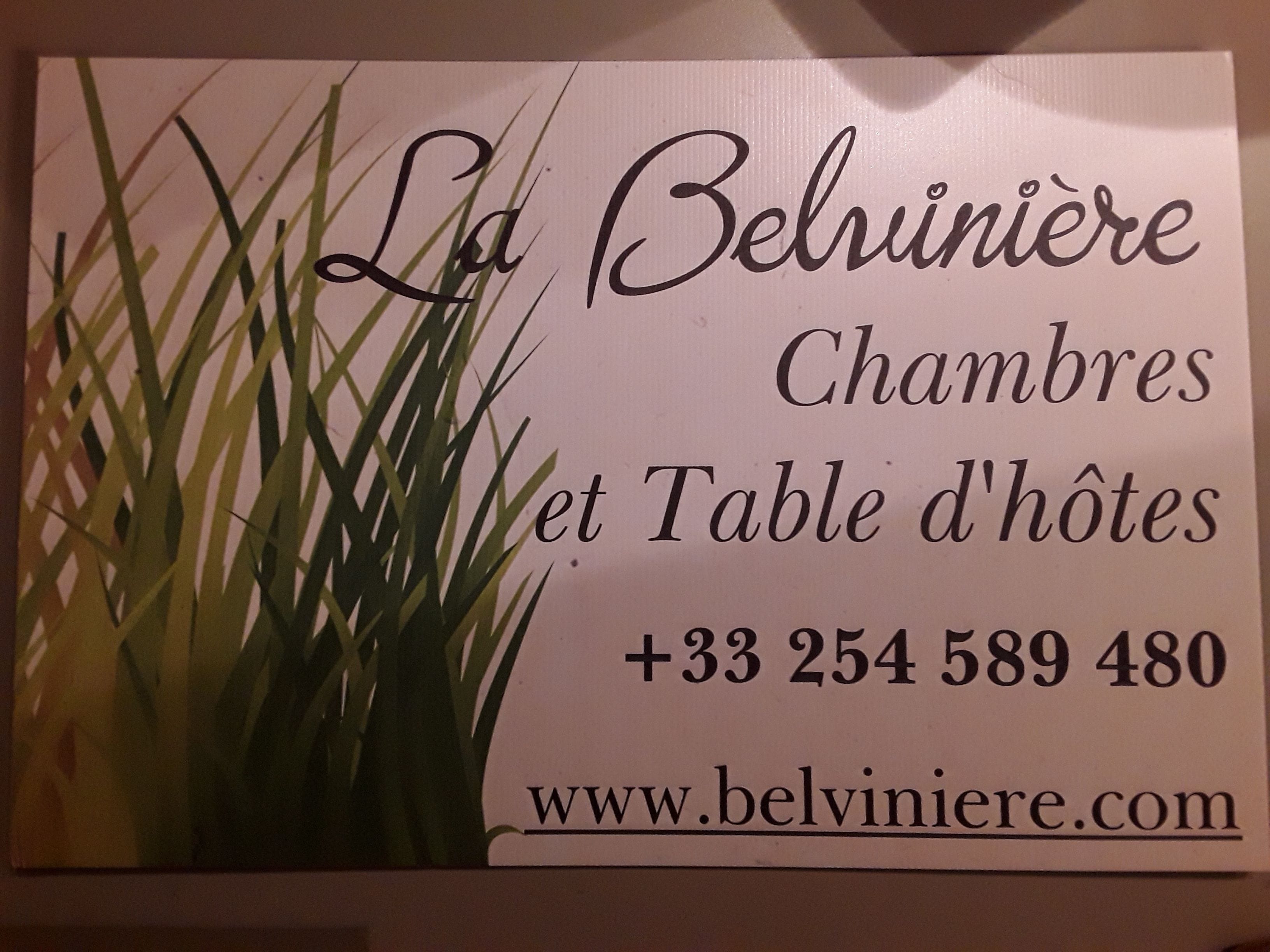 A sign with the name "La Belviniere" and contact information.