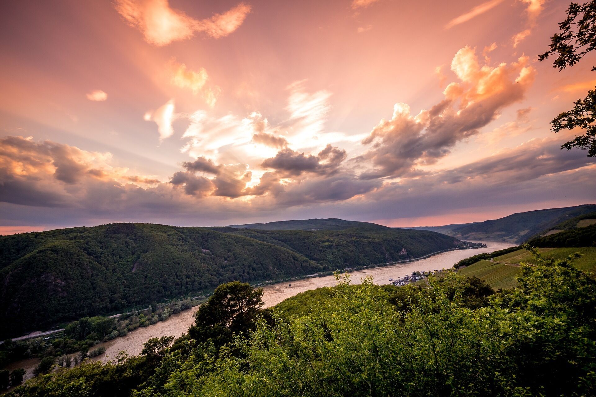A river flowing through a valley with hills on either side.
