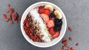 A bowl of food with various fruits and nuts.