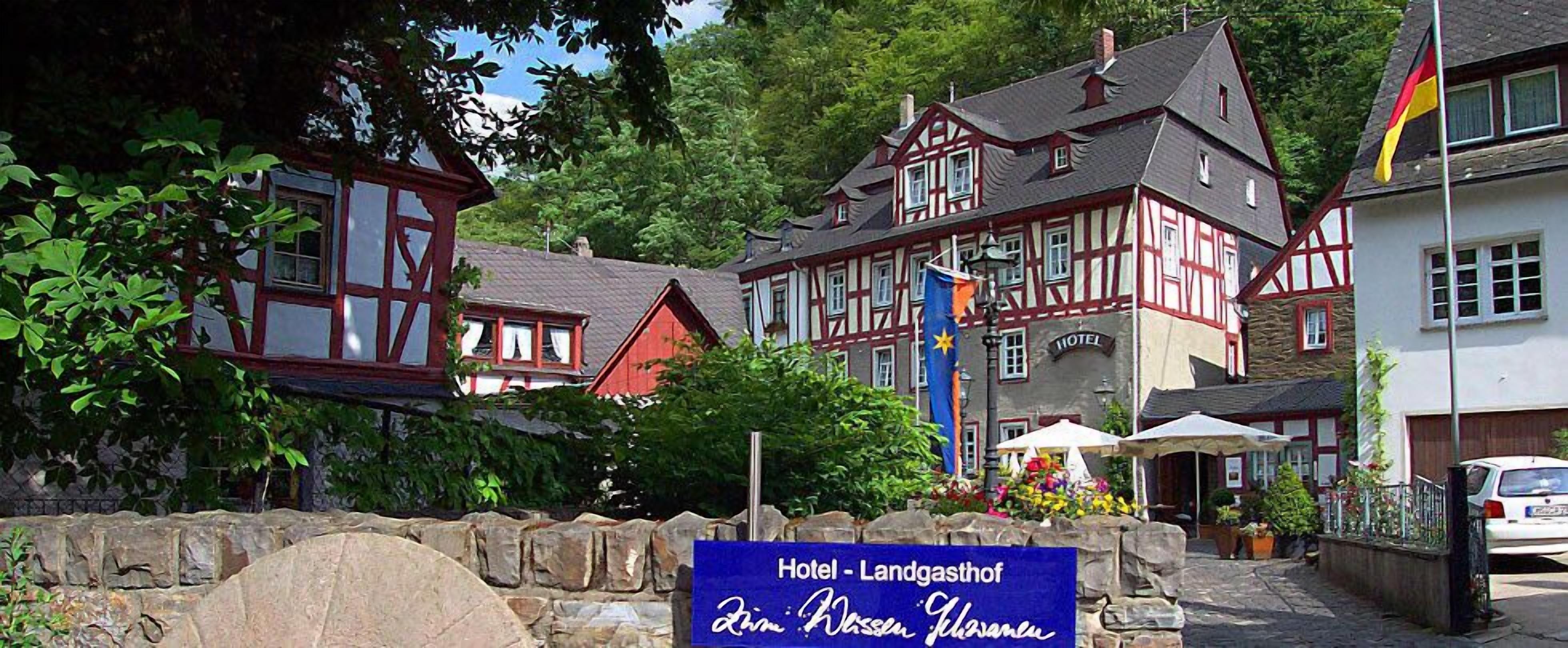 A traditional half-timbered building with a sign indicating it is a hotel.