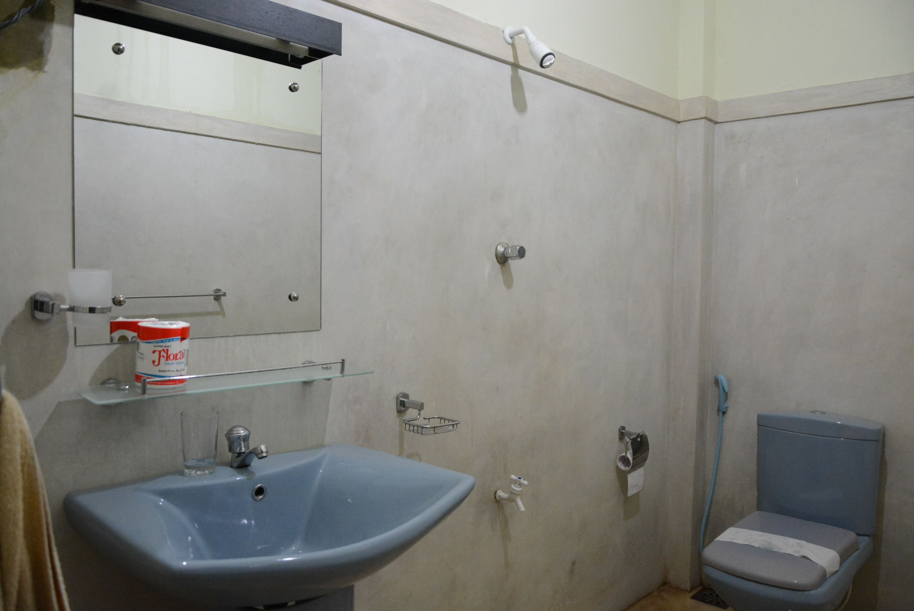 A bathroom with a sink, toilet, and shower.