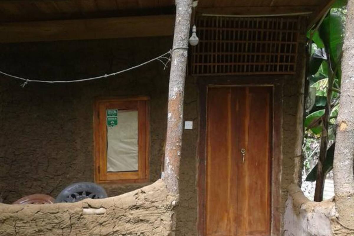 A rustic building with a wooden door and a small window.