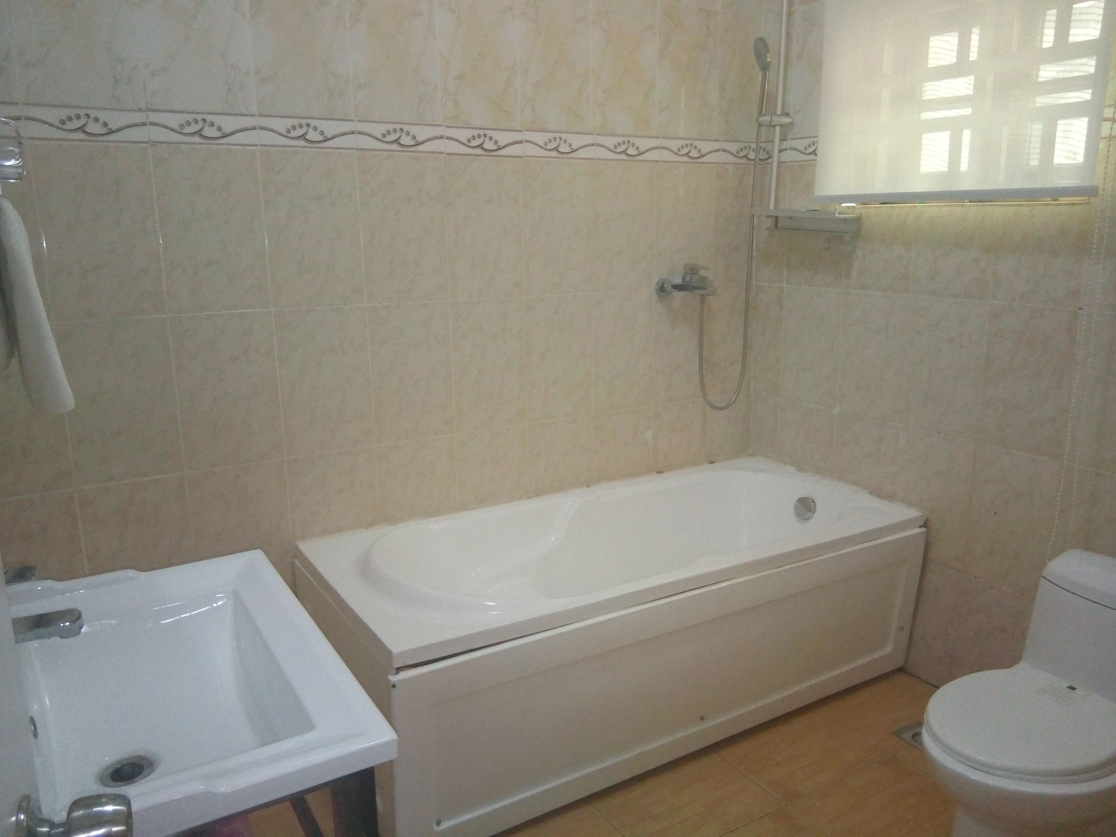 A bathroom with a bathtub, a sink, and a toilet.