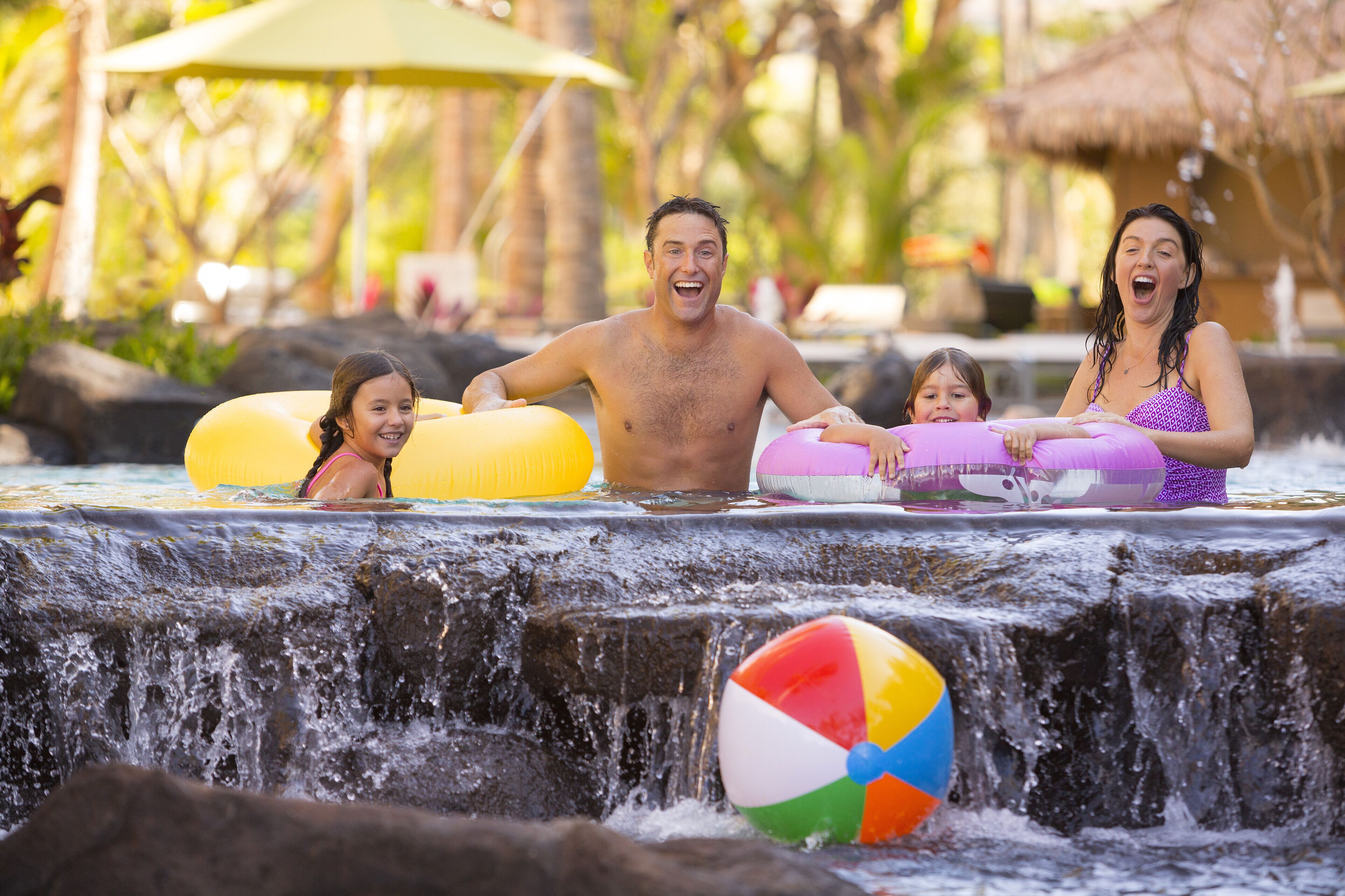 A water feature with a waterfall and inflatable rings.