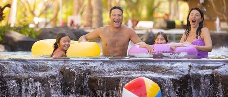 A water feature with a waterfall and inflatable rings.
