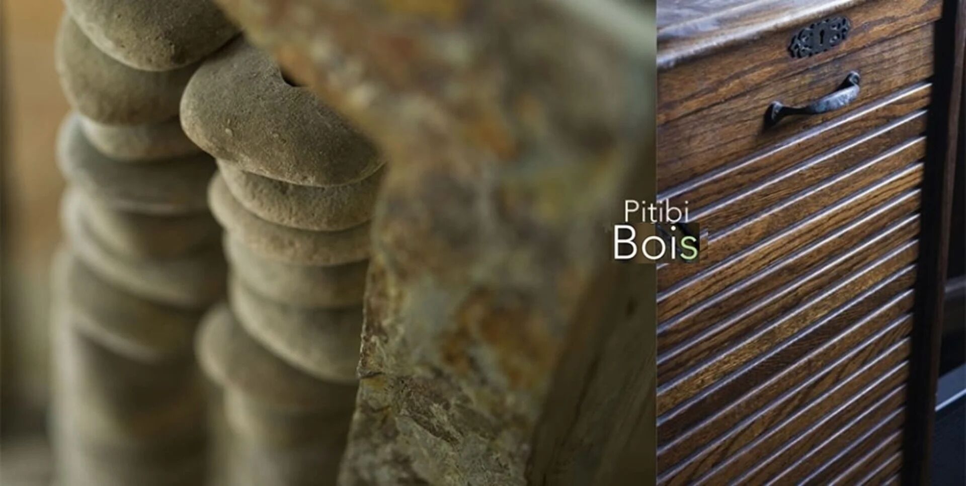 Een close-up van gestapelde stenen en een houten lade met een metalen handvat.