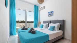 A bedroom with a large bed, two bedside tables, a window with curtains, and a view of the outdoors. - Villa Bella, 5 bedrooms with Private Pool, Hot Tub, Games Room near to beach (Lardos)