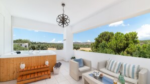 A modern outdoor living area with a wooden hot tub, wicker furniture, and a view of green trees and hills. - Villa Bella, 5 bedrooms with Private Pool, Hot Tub, Games Room near to beach (Lardos)