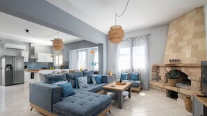 A modern living room with a grey sofa, a coffee table, and a fireplace. - Villa Bella, 5 bedrooms with Private Pool, Hot Tub, Games Room near to beach (Lardos)