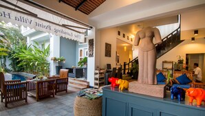 A spacious lobby with a pool area, a staircase, and a reception desk. - Landing Zone Boutique Hotel (Siem Reap)