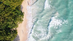 An aerial view of a beach with clear turquoise waters and a sandy shore. - Coral Reef Resort & Spa, Havelock (Port Blair)