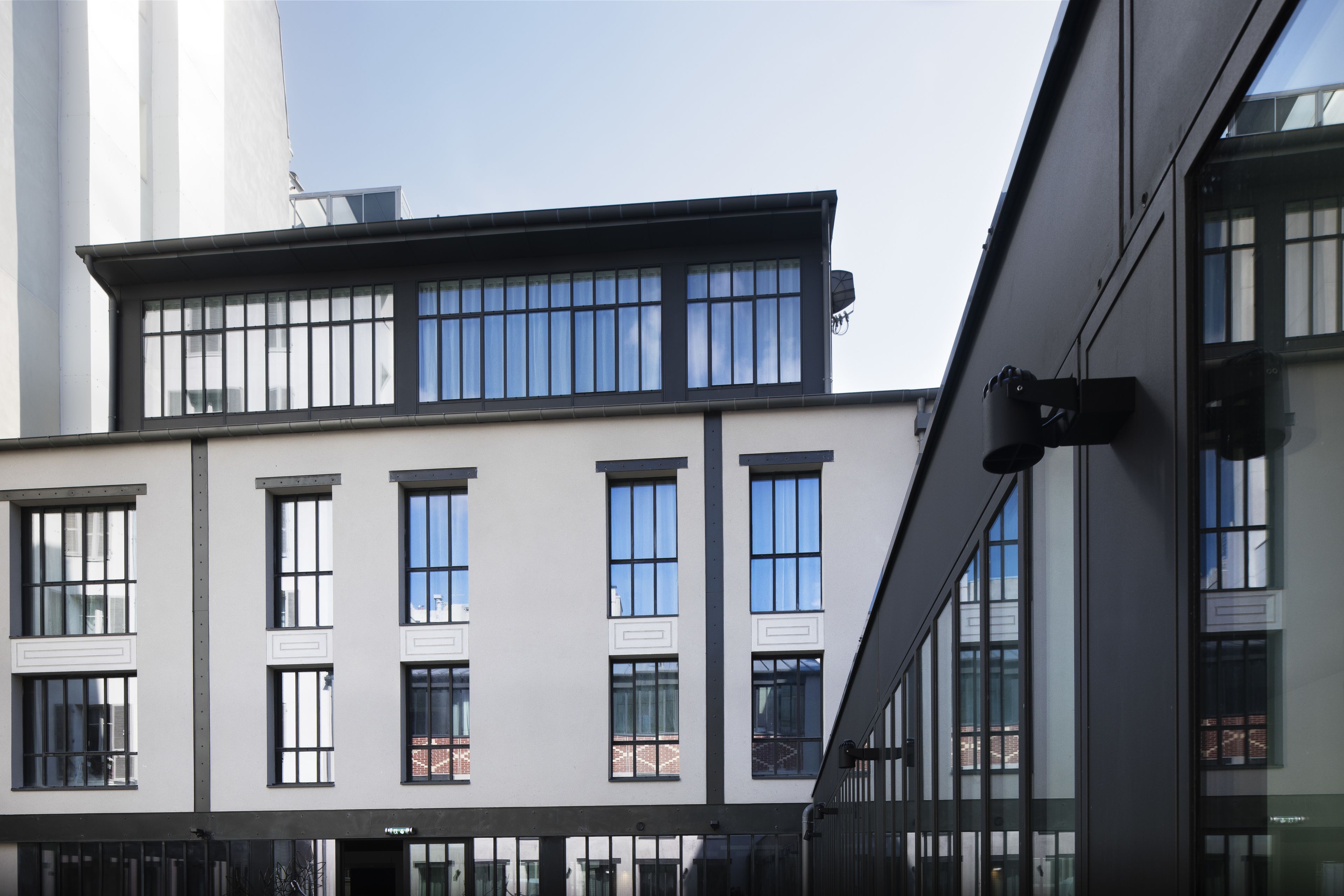 A modern building with large windows and a flat roof.