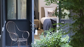 Une chambre d’hôtel moderne, équipée d’un lit, d’une chaise et d’une petite table.