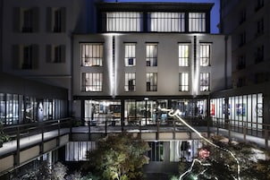 A multi-story building with large windows and a central atrium.