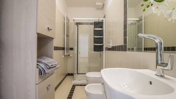 Apartment, 1 Bedroom | Bathroom | Shower, deep soaking tub, towels, shampoo