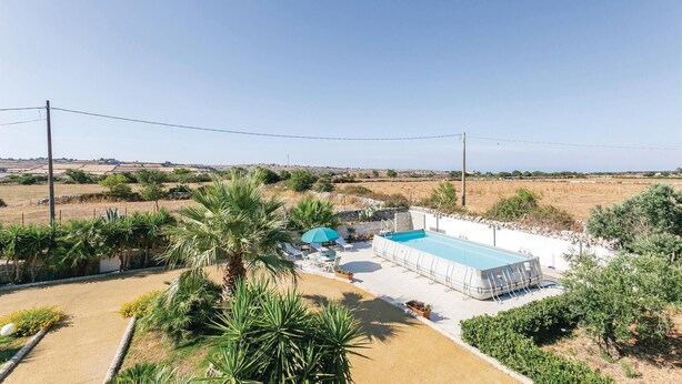 A pool area with a clear view of the surrounding landscape, including fields and distant hills. - Villa Betty (Ragusa -RG-)