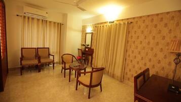 Suite – grand | Oppholdsområde | En 32-tommers smart-TV med Parabol-TV samt peis