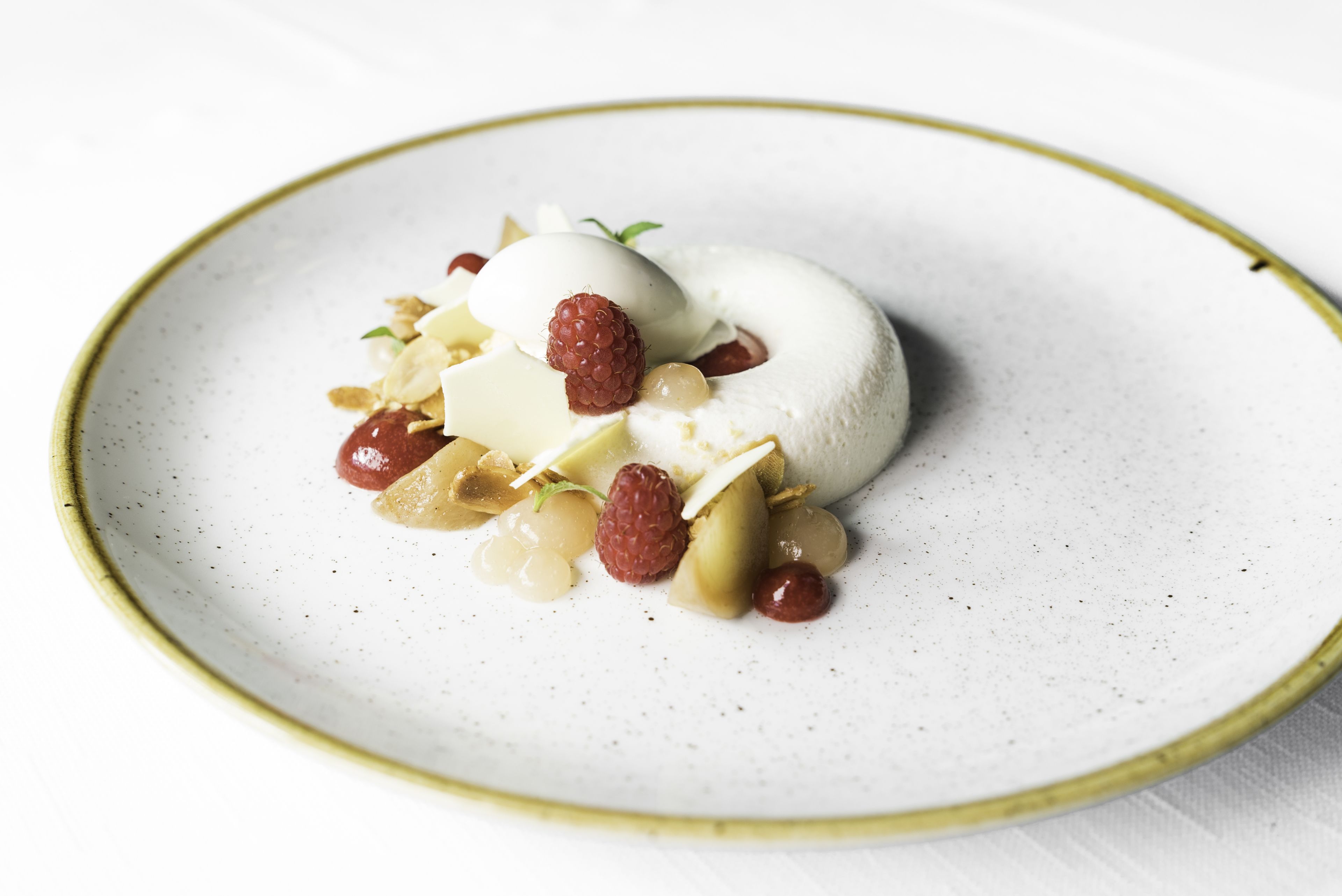 A dessert on a plate with a white and gold rim.