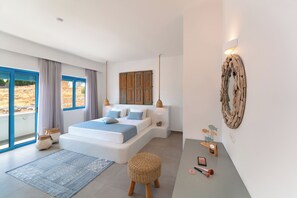 A modern bedroom with a large bed, a view through the window, and a wall-mounted light fixture. - Lindos Portes Suites - Adults Only (Rhodes)