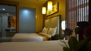 A hotel room with two beds, a bathroom, and a large window with blinds. - Kololo Courts Hotel & Restaurant (Kampala)
