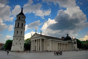 A large historical building with a prominent tower and a dome. - Apartments in Latako and Pilies Streets (Vilnius)