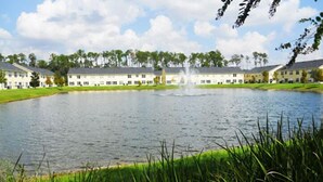 A large building with multiple windows and a fountain in the center. - Club Cortile Resort #1 - 4 Bed 3 Baths Townhome (Kissimmee)