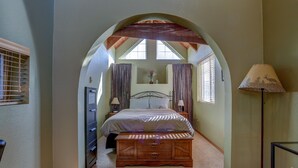 Ein Schlafzimmer mit Bett, Nachttisch, Lampe und Kommode.