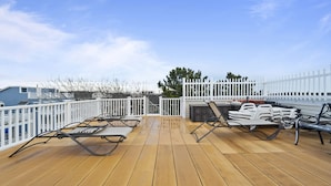 A wooden deck with metal loungers and a white fence. - 10Bd/10Ba Large Beach Home, Indoor Pool In Virginia Beach (Virginia beach)